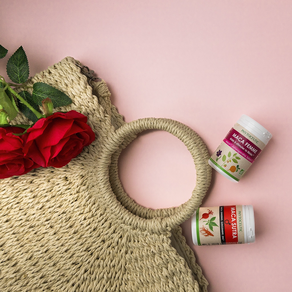 Sac en paille, roses rouges, compléments Maca Femme et Maca Sutra Phytoceutic fond rose