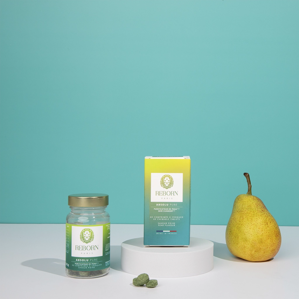 Compléments Reborn Absolu+ Pure, pot et boîte vert-jaune, poire fraîche, fond vert d’eau.