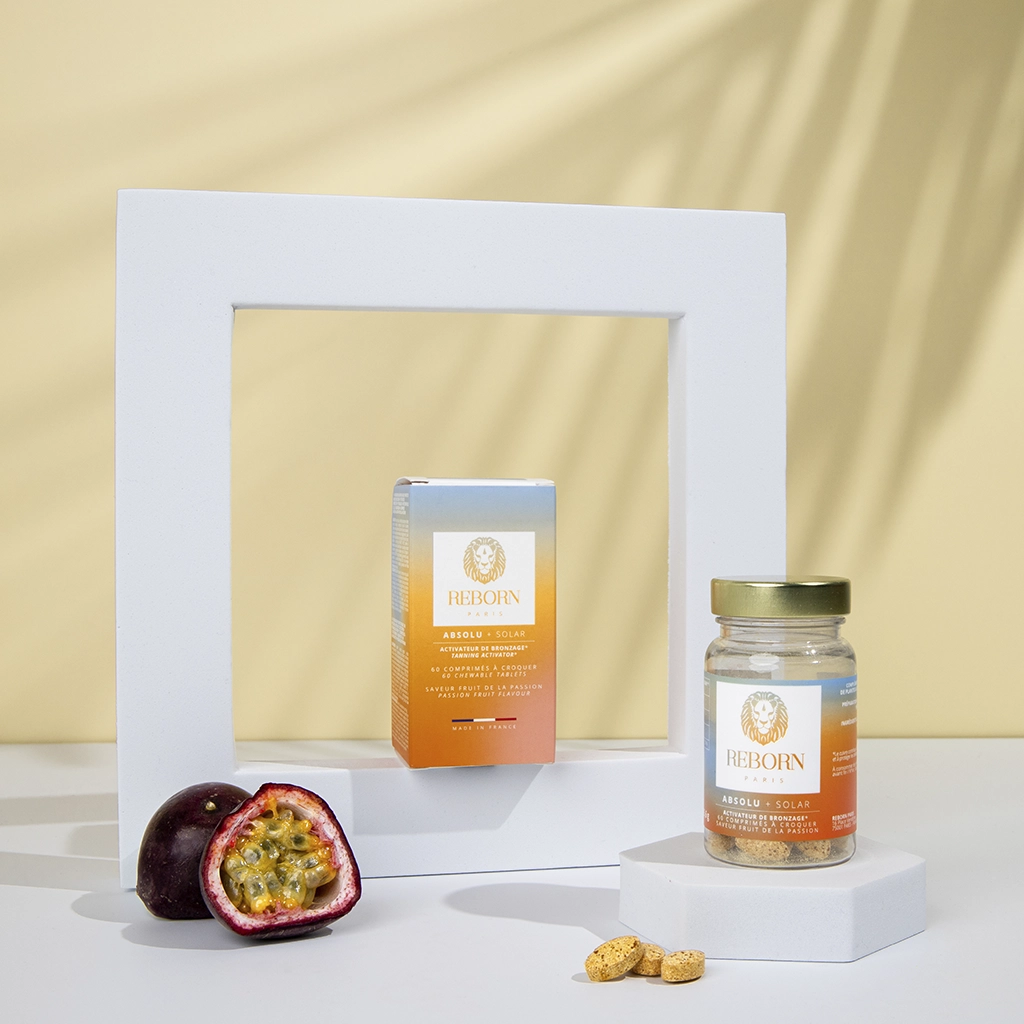 Compléments Reborn Absolu+ Solar, boîte et pot orangés, fruit de la passion, fond jaune soleil.