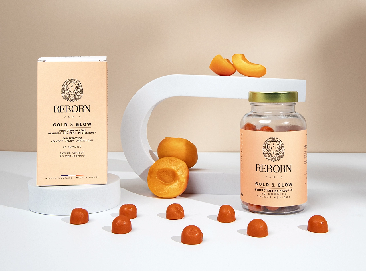 Gummies Reborn Paris Gold & Glow abricot, boîte et pot verre, abricots frais, packshot beauté.